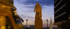 statue and tram during after sunset