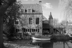 House, boat and city gate in the back
