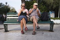 Tourist couple eating ice cream