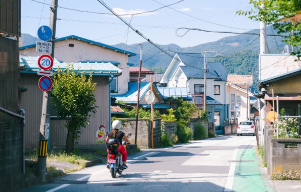 A girl riding a scooter in Kawaguchiko