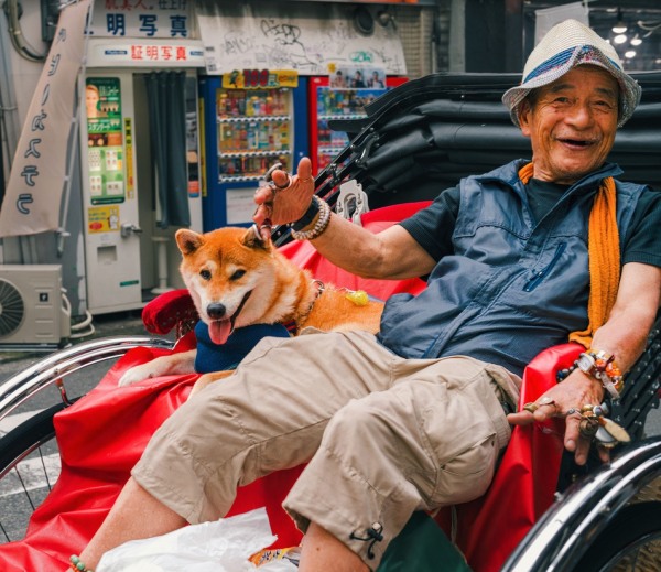 Man and his dog riding a rickshaw
